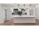 Beautiful kitchen features an island, modern appliances, and black backsplash at 3203 S Polk Ave, Lakeland, FL 33803