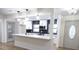 Bright kitchen with a large island, modern finishes, pendant lighting and white cabinets at 3203 S Polk Ave, Lakeland, FL 33803