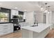 Beautiful kitchen features an island, modern appliances, and black backsplash at 3203 S Polk Ave, Lakeland, FL 33803