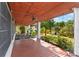 Covered patio overlooking the yard, featuring a wood ceiling, ceiling fan and mature landscaping at 3203 S Polk Ave, Lakeland, FL 33803