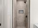 Tiled shower with a black rainfall shower head and decorative shower niche at 3203 S Polk Ave, Lakeland, FL 33803