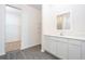 Modern bathroom featuring beautiful flooring, an elegant vanity, and a walk-in closet at 13469 Leaping Water Way, Astatula, FL 34705