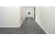 Inviting hallway with gray wood-look floors leading to the front door at 13469 Leaping Water Way, Astatula, FL 34705