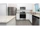 Beautiful kitchen with stainless steel appliances, granite countertops, and white cabinetry at 13469 Leaping Water Way, Astatula, FL 34705