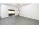 Spacious living room with sliding glass doors and stylish gray wood-look floors at 13469 Leaping Water Way, Astatula, FL 34705