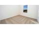 Empty bedroom with neutral carpet and a bright window at 13465 Leaping Water Way, Astatula, FL 34705