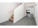 Hallway with hard surface flooring, a staircase with carpet treads, and a view to the living room at 13465 Leaping Water Way, Astatula, FL 34705