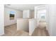 Bright upstairs hallway with neutral carpet leading to bedrooms and featuring natural light from a window at 13465 Leaping Water Way, Astatula, FL 34705