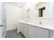 Modern bathroom with a double sink vanity, framed mirrors, and a glass-enclosed shower at 13466 Leaping Water Way, Astatula, FL 34705