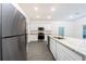 Well-equipped kitchen featuring granite countertops, stainless steel appliances and bright white cabinetry at 13466 Leaping Water Way, Astatula, FL 34705