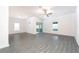 Bright living room with hard surface floors, ceiling fan, and a sliding door to the exterior at 13466 Leaping Water Way, Astatula, FL 34705