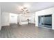 A spacious living room features hard surface floors, a ceiling fan, and a sliding glass door to the lanai at 13466 Leaping Water Way, Astatula, FL 34705