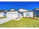 Inviting home exterior with manicured lawn and walkway to the front door at 13473 Leaping Water Way, Astatula, FL 34705