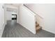 Hallway with hardwood floors leads to the living room, staircase, and large glass sliding doors at 13485 Leaping Water Way, Astatula, FL 34705