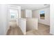 Bright hallway features neutral carpeting, white walls, and natural light from the window at 13485 Leaping Water Way, Astatula, FL 34705