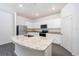 Modern kitchen featuring white cabinets, stainless steel appliances, and granite countertops at 13485 Leaping Water Way, Astatula, FL 34705