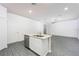 Kitchen with white cabinetry, stainless steel appliances and island with a sink at 13485 Leaping Water Way, Astatula, FL 34705