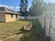 Backyard with grassy lawn, wooden fence, and raised garden bed at 341 N Fork Dr, Lakeland, FL 33809