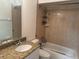 Clean bathroom with a bathtub, shower, and granite countertop vanity at 341 N Fork Dr, Lakeland, FL 33809