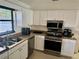 Bright kitchen featuring stainless steel appliances and granite countertops at 341 N Fork Dr, Lakeland, FL 33809