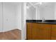 Bathroom vanity with wooden cabinets, black countertop and modern fixtures, offers a minimalist design at 150 E Robinson St # 221, Orlando, FL 32801