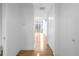 Hallway with wood floors leads to a brightly lit living area, creating an inviting atmosphere at 150 E Robinson St # 221, Orlando, FL 32801