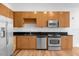 Modern kitchen with stainless steel appliances and wooden cabinetry, blending style and functionality at 150 E Robinson St # 221, Orlando, FL 32801