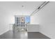Bright living room featuring neutral walls, hard floors, a modern chandelier, and a large window with urban views at 150 E Robinson St # 221, Orlando, FL 32801