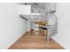 Bright living room featuring an open floor plan, hardwood floors, and a modern spiral staircase at 150 E Robinson St # 221, Orlando, FL 32801