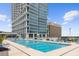 Rooftop pool with lounge chairs, beautiful city views, and modern high-rise building as a backdrop at 150 E Robinson St # 221, Orlando, FL 32801