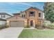 Two-story house with a neutral color scheme and landscaped lawn at 2804 Polson Dr, Kissimmee, FL 34758