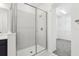 Modern bathroom featuring a glass-enclosed shower and access to a walk-in closet at 520 Astera Winds Ln, Lake Mary, FL 32746