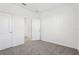 Bright bedroom featuring neutral carpet, white walls, and an adjoining walk-in closet at 520 Astera Winds Ln, Lake Mary, FL 32746