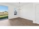 Bright dining room with wood floors, view to the yard, modern light fixture at 520 Astera Winds Ln, Lake Mary, FL 32746