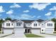 Two-story townhome with gray siding, white accents, and two-car garages at 520 Astera Winds Ln, Lake Mary, FL 32746