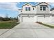 New two-story townhome with a two-car garage, modern facade, and a well-manicured front lawn at 520 Astera Winds Ln, Lake Mary, FL 32746