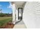 Inviting front porch featuring a white brick wall, black door and two columns at 520 Astera Winds Ln, Lake Mary, FL 32746