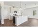 Open kitchen featuring stainless steel appliances, white cabinets and island, and pendant lighting at 520 Astera Winds Ln, Lake Mary, FL 32746