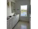 Bathroom featuring large vanity with marble countertop and sleek fixtures with a view to backyard lake at 13467 Panama Beach Ct, Orlando, FL 32827