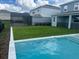 Backyard view featuring pool with white marble trim and lush green grass at 13467 Panama Beach Ct, Orlando, FL 32827