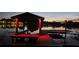 Private boat dock with covered area and red lighting at night at 509 E Lakeshore Dr, Ocoee, FL 34761