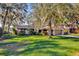 House exterior showcasing a lush lawn and mature trees at 509 E Lakeshore Dr, Ocoee, FL 34761