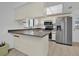 Kitchen boasts stainless steel appliances and a breakfast bar at 509 E Lakeshore Dr, Ocoee, FL 34761