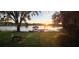 Scenic waterfront view with a private dock at sunset at 509 E Lakeshore Dr, Ocoee, FL 34761