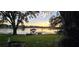 Scenic waterfront view with a private dock at sunset at 509 E Lakeshore Dr, Ocoee, FL 34761