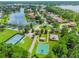 Aerial shot features community tennis courts, basketball court, playground, and lakes at 2024 Capri Ln, Mount Dora, FL 32757
