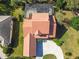 Aerial view of a tile roof home with screened pool and well-maintained landscaping at 2024 Capri Ln, Mount Dora, FL 32757