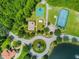 Aerial view of community amenities featuring a playground, tennis courts, and basketball court at 2024 Capri Ln, Mount Dora, FL 32757