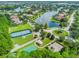 Aerial view of the community showcasing tennis courts, playground, and scenic lake views at 2024 Capri Ln, Mount Dora, FL 32757