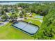 Community aerial showcasing tennis courts, playground, basketball court, lake, and landscaping at 2024 Capri Ln, Mount Dora, FL 32757